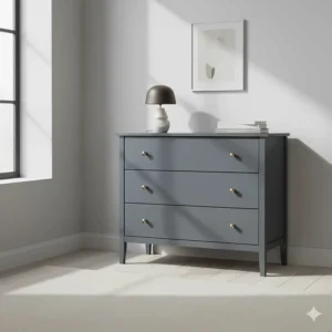 Modern chest of drawers painted in a soft anthracite grey with brushed brass knobs.