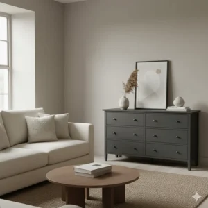 A dark grey chest of drawers used for storage in a neutral-toned British living room.