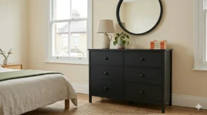 Alt text for image 9: A classic Shaker-style black chest of drawers with simple panelled drawer fronts and traditional matching wooden knobs.