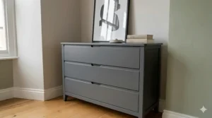 A contemporary charcoal grey assembled chest of drawers with a minimalist handleless design.