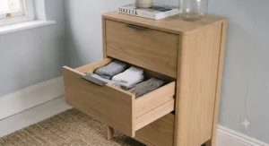 Close-up of a three-drawer chest with one drawer opened to show storage.