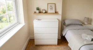 A sleek, minimalist white chest of drawers blending seamlessly into a bright, contemporary spare bedroom.