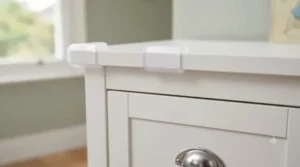 Soft, clear silicone corner protectors attached to the edges of a wooden chest of drawers.