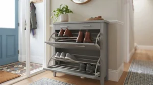 A modern grey painted shoe storage cabinet keeping an entryway tidy and clutter-free.
