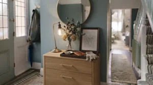 A narrow chest of drawers styled with a lamp and vase, showing storage and display potential.