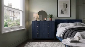 Elegant painted statement chest of drawers adding a pop of colour to a neutral bedroom decor.