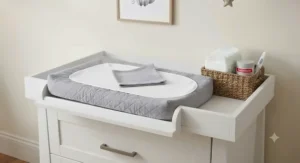 Removable wooden changing top attachment secured to the top of a nursery dresser.