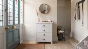 A rustic traditional pine chest of drawers adding classic charm and extra storage to a period hallway.