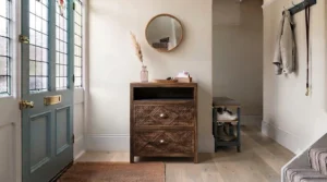 A white hallway cabinet with wicker storage baskets and pull-out drawers for tidy family boot room organisation.