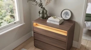 Visual comparison showing soft ambient under-shelf lighting on a modern drawer unit next to a standard unlit bedside storage unit.