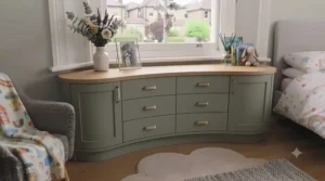 Custom-fit low chest of drawers nestled neatly inside a traditional British bay window