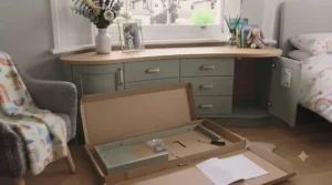Flat pack under window chest of drawers during home assembly with anti-tip wall straps