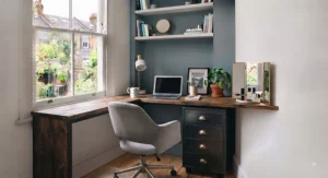 Industrial-style metal frame desk and drawers combination set against a feature wall in a modern flat.