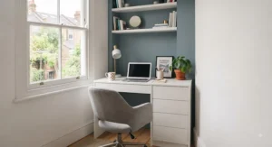 White minimalist desk and drawers combination styled in a bright, narrow bedroom to reflect natural light.
