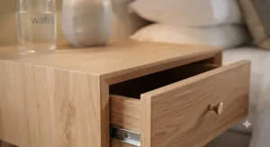 Detail shot highlighting the natural oak wood grain and durable finish of a slim bedside unit.