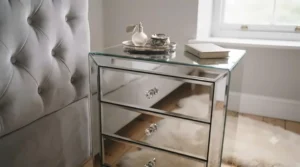 Close-up shot of a glamorous mirrored 3 drawer bedside table highlighting crystal drawer pulls.